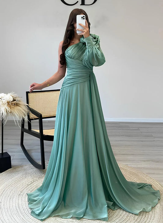Model wearing a dusty teal A-line prom dress with a one-shoulder puff sleeve and ruched waist, front view.