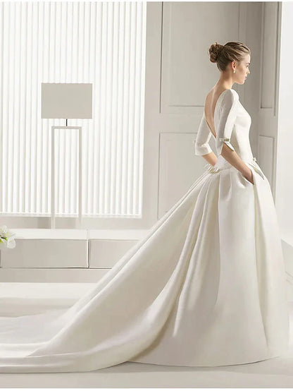 Side view of a plus size bride wearing an A-Line wedding dress, showcasing the flowing skirt and court train.