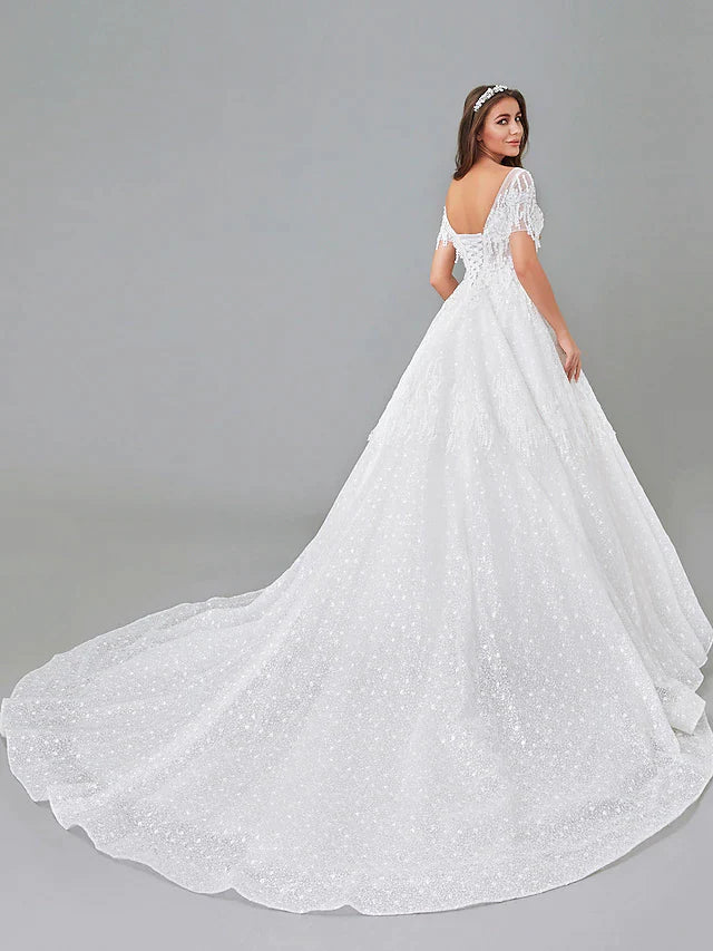 Close-up of the lace bodice and bateau neckline of the wedding dress.