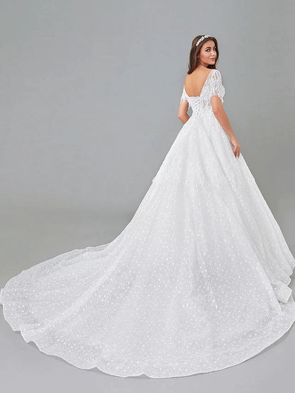 Close-up of the lace bodice and bateau neckline of the wedding dress.