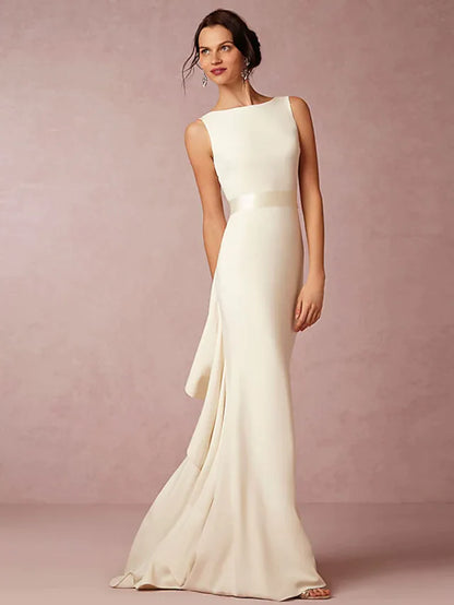 Bride wearing an elegant white satin bateau neck wedding dress with draped detailing.