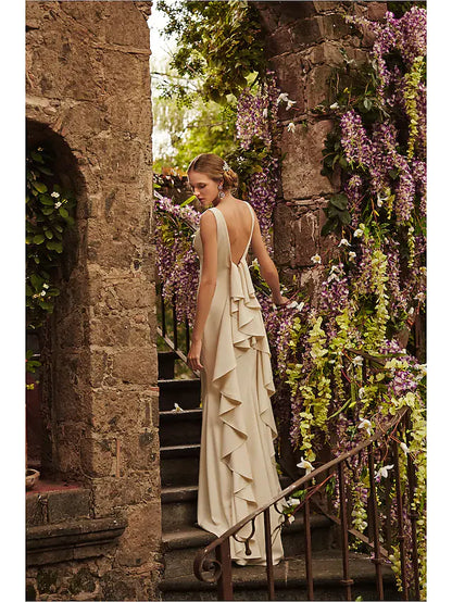 Side profile of a bride in a white satin vintage wedding gown with a full skirt.