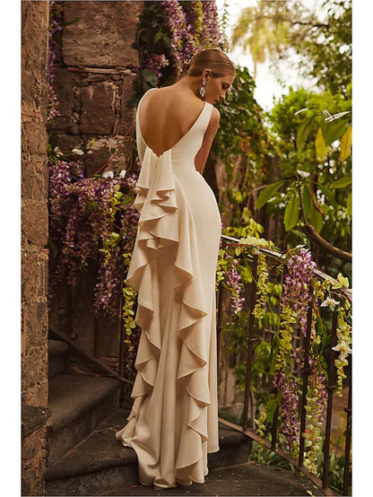 Front view of a white satin wedding dress featuring a bateau neckline and elegant draping.