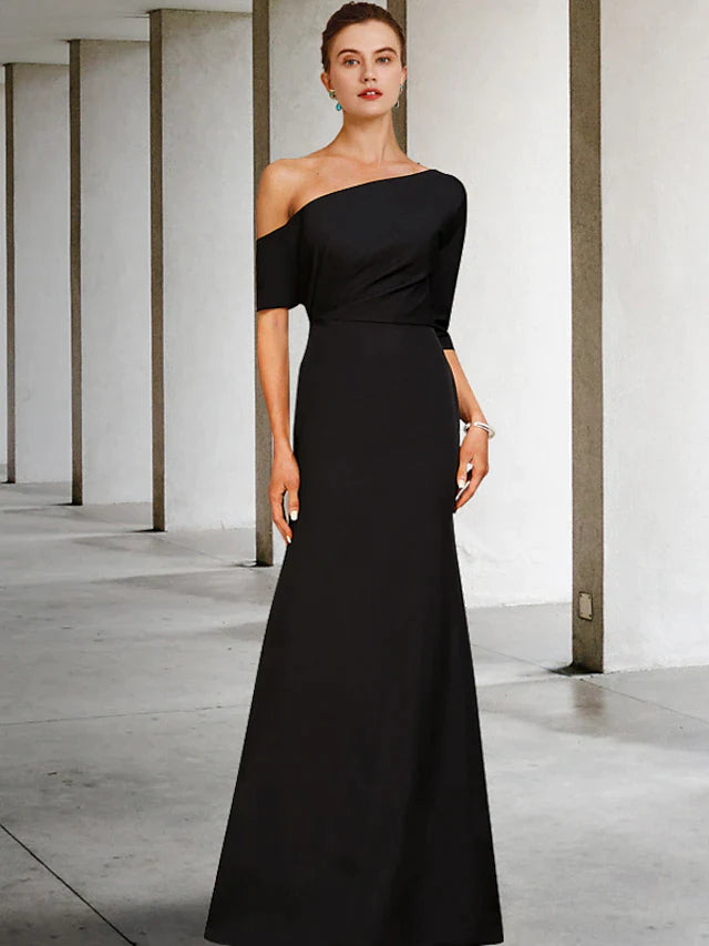 Woman wearing an elegant navy blue A-line one-shoulder Mother of the Bride dress with 3/4 sleeves and ruffles.