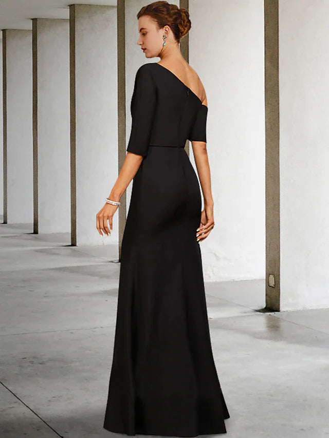 Side view of a woman in a navy blue A-line Mother of the Bride dress, showcasing the one-shoulder design and side draping.