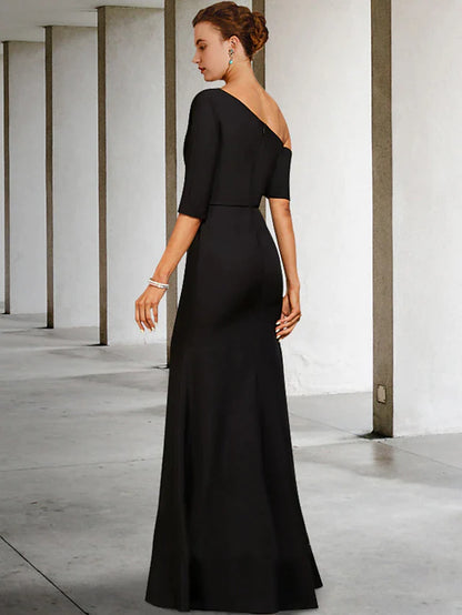 Side view of a woman in a navy blue A-line Mother of the Bride dress, showcasing the one-shoulder design and side draping.