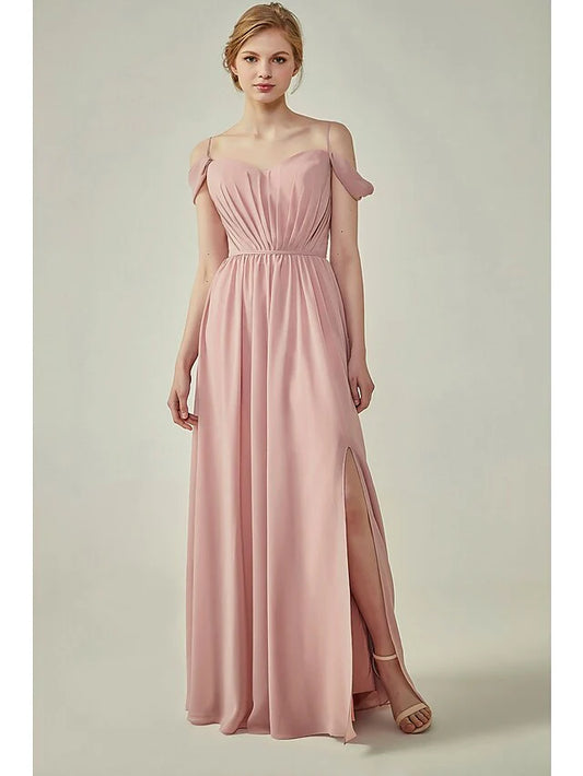 Woman wearing an A-Line chiffon bridesmaid dress with spaghetti straps, ruching, and a sash ribbon.