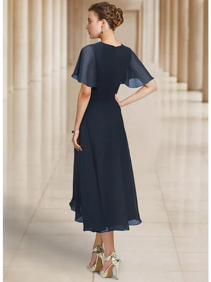 Back view of the A-line chiffon dress, showing asymmetrical details and pleats.