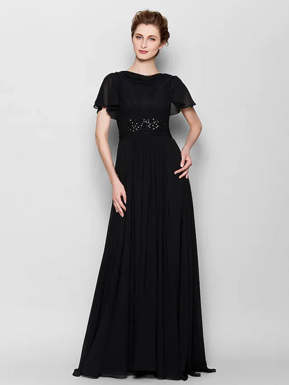 Close-up of the beaded bateau neckline and short sleeves on the chiffon dress.