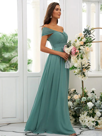 A woman wearing an elegant A-line off-the-shoulder floor-length bridesmaid dress.