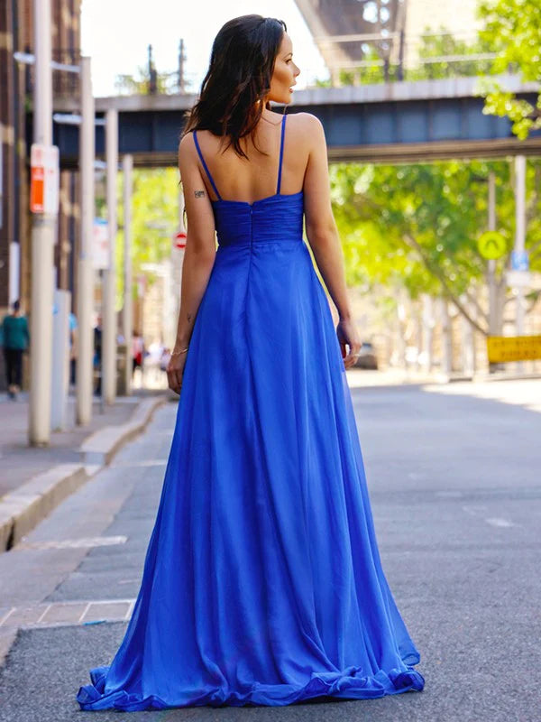 Side view of a woman wearing the blue ruched spaghetti strap prom dress.