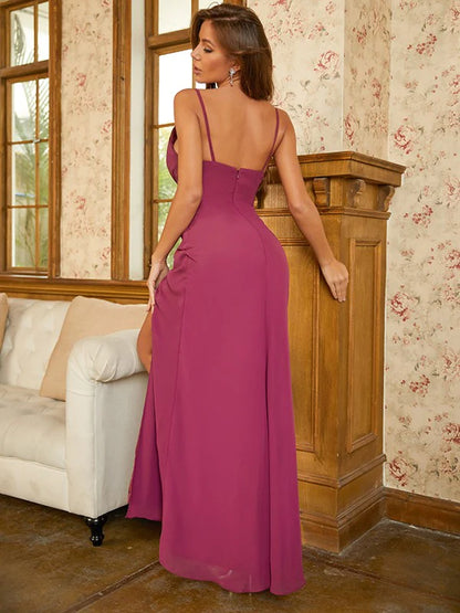 Back view of a woman in a floor-length sleeveless chiffon gown.