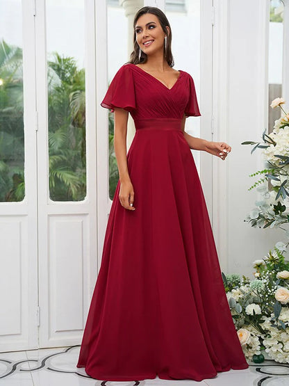 Full length view of an A-line chiffon bridesmaid dress with V-neck and short sleeves.