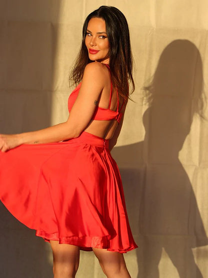 Back view of a sleeveless A-line mini dress featuring delicate ruffles.
