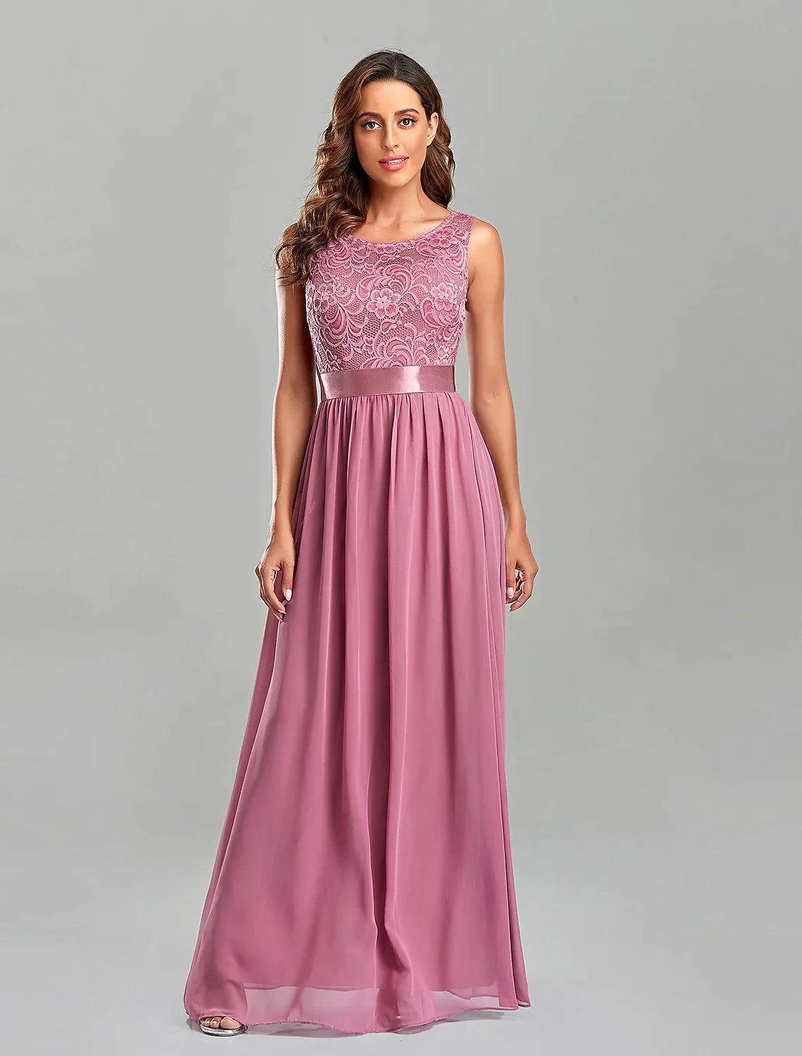 Close-up of the embroidered jewel neck and short sleeves on the chiffon gown.