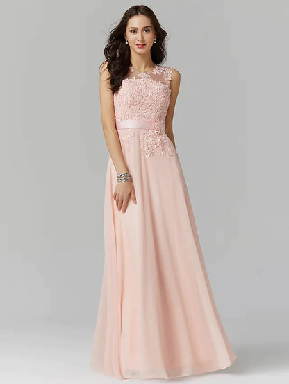 Model in elegant A-line empire prom dress with illusion neck and beaded lace appliques.