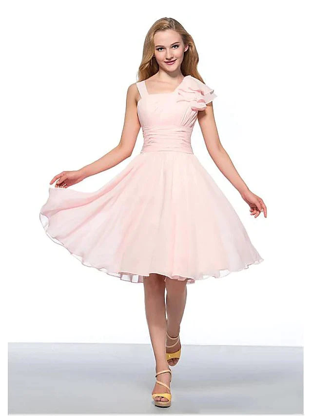Model wearing an elegant A-Line Empire jewel neck ruched knee-length cocktail dress.
