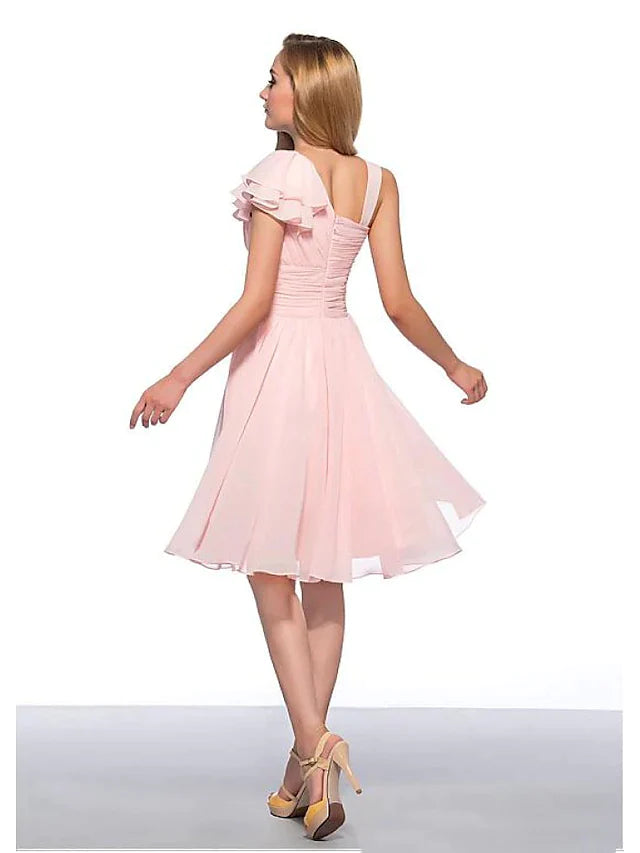 Back view of a woman in a light blue sleeveless knee-length chiffon dress with ruched detailing.