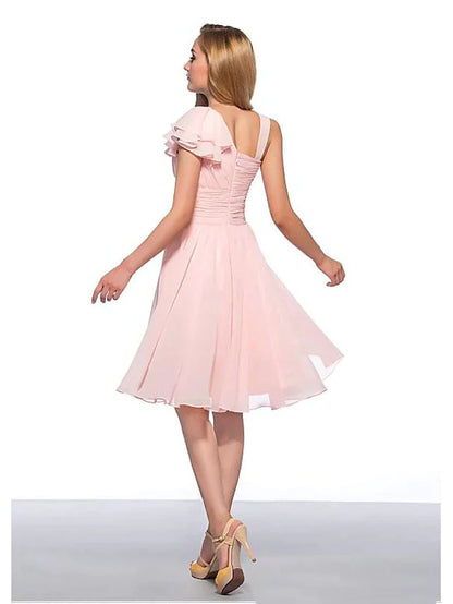 Back view of a woman in a light blue sleeveless knee-length chiffon dress with ruched detailing.