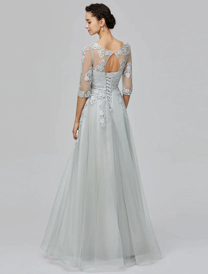 Woman in A-Line Empire tulle dress, side view, showcasing bow appliques on the skirt.