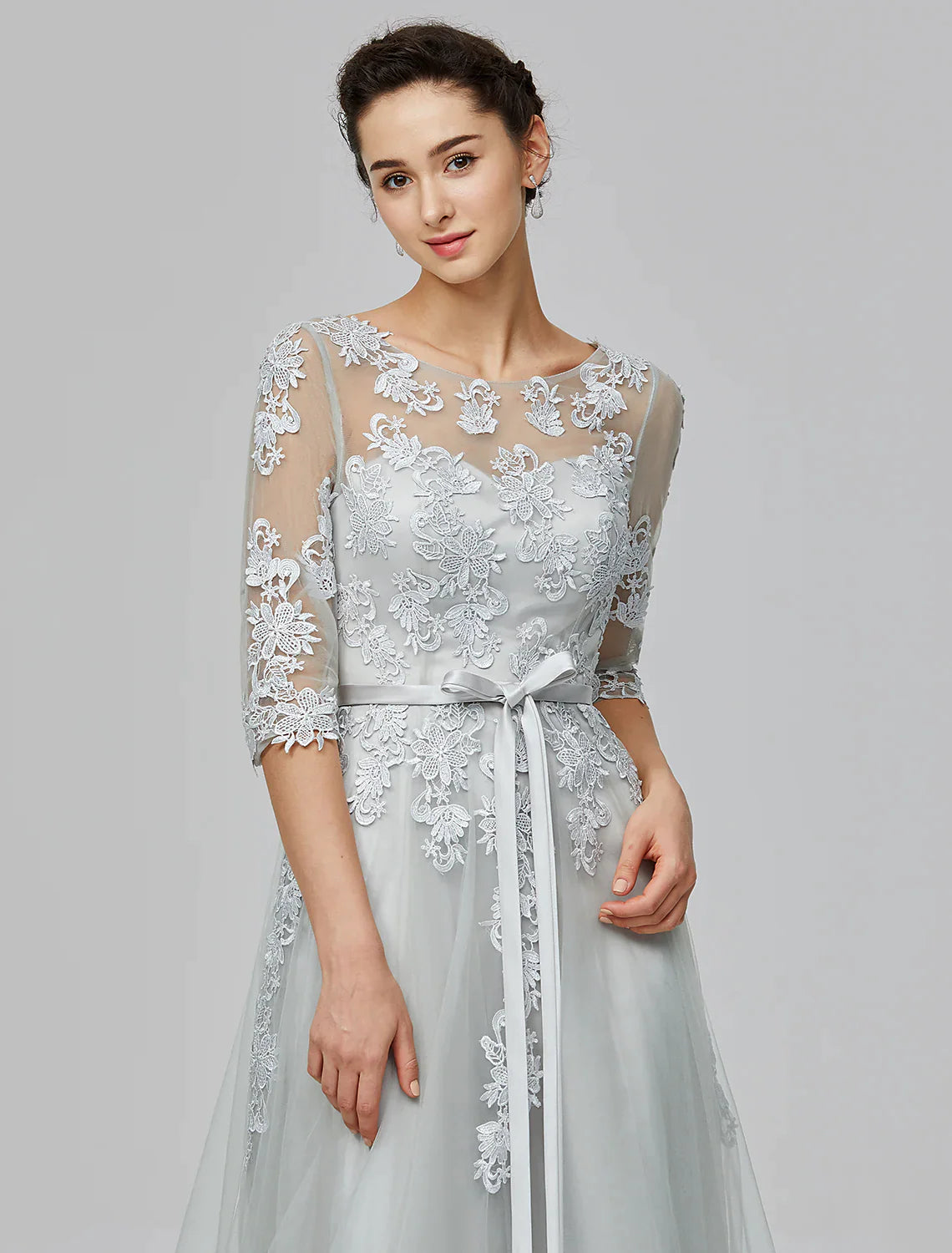 Woman in A-Line Empire tulle dress in a walking pose, showing the flow of the floor-length skirt.