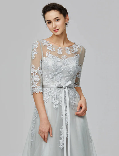 Woman in A-Line Empire tulle dress in a walking pose, showing the flow of the floor-length skirt.