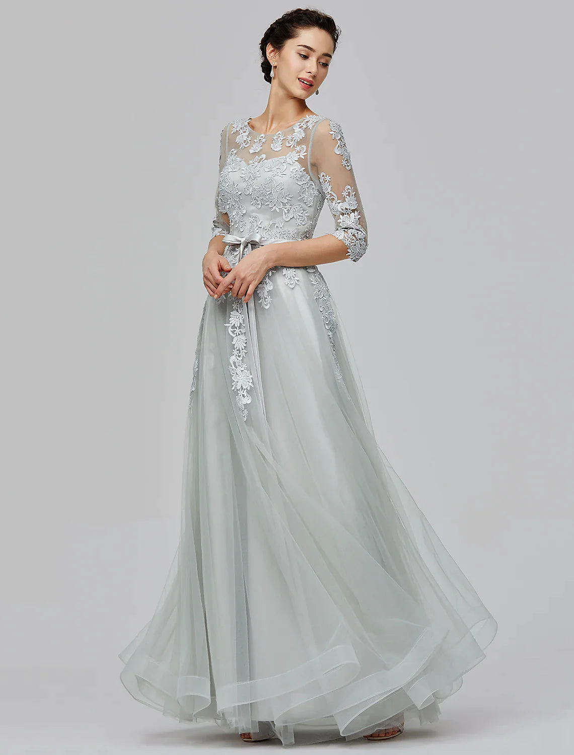 Full length view of a woman wearing the A-Line Empire tulle dress, showcasing the overall design.