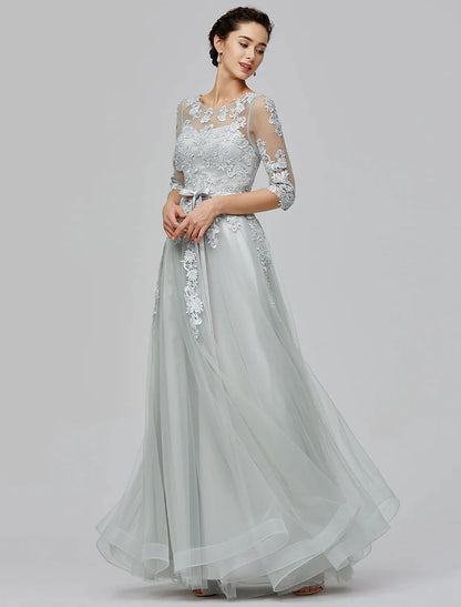 Full length view of a woman wearing the A-Line Empire tulle dress, showcasing the overall design.