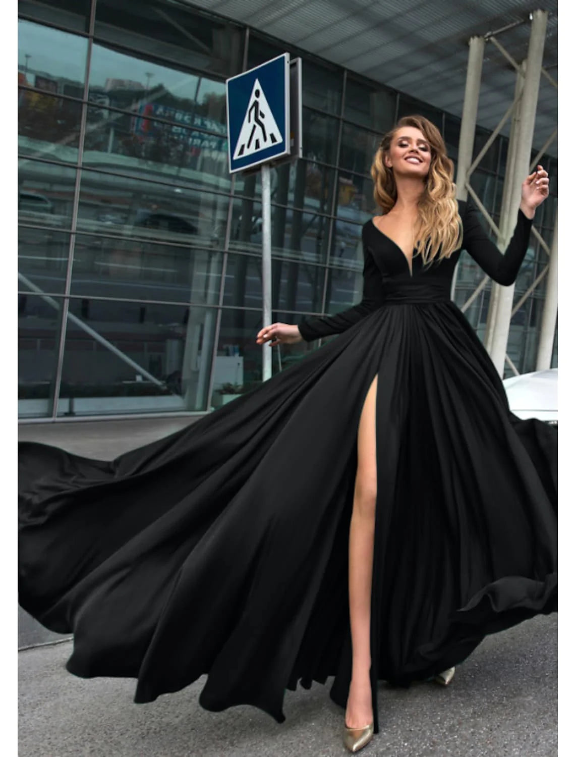 Woman wearing a pure color A-line empire long sleeve V-neck evening gown.