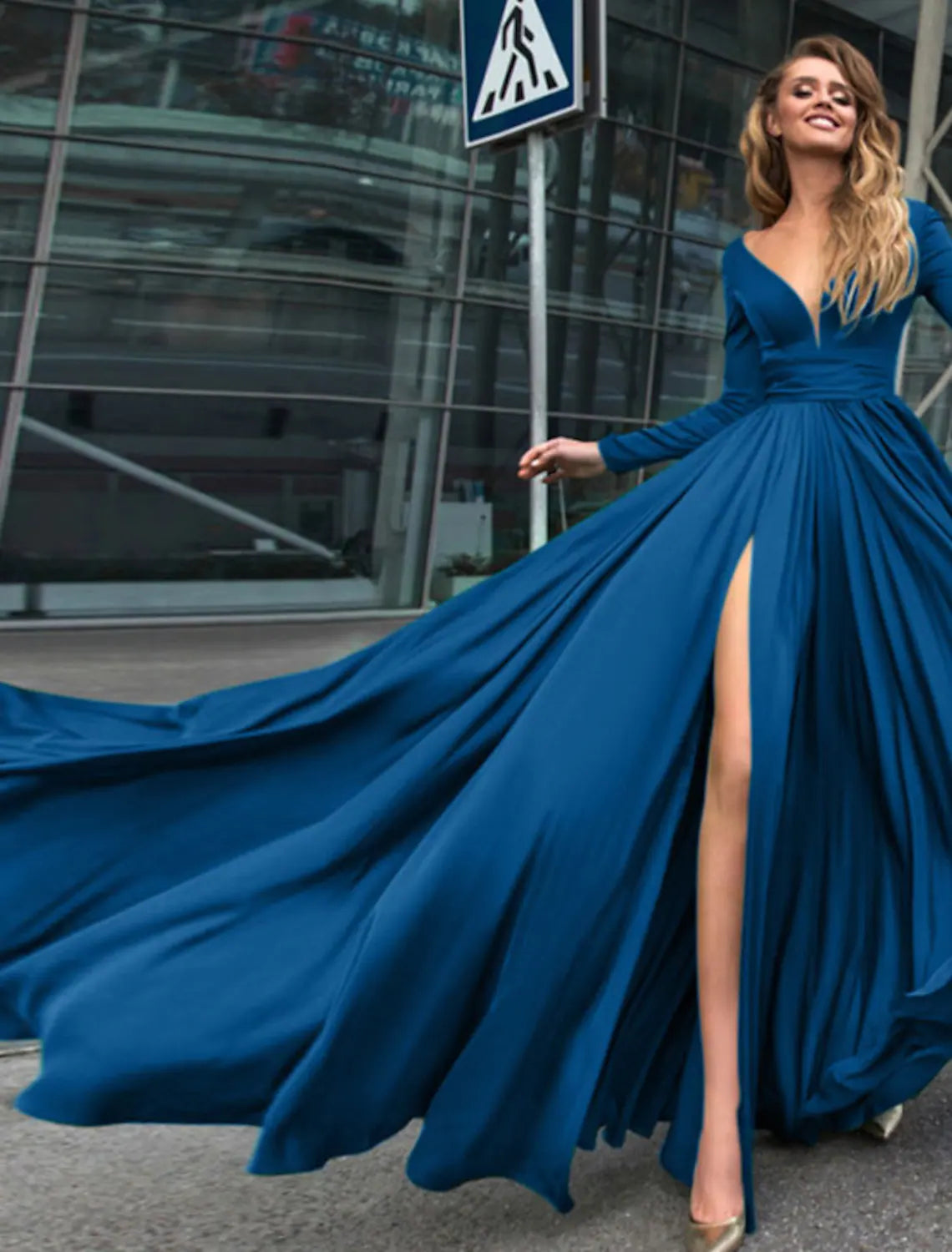 Close-up of the V-neck and long sleeves of a pure color A-line empire evening gown.