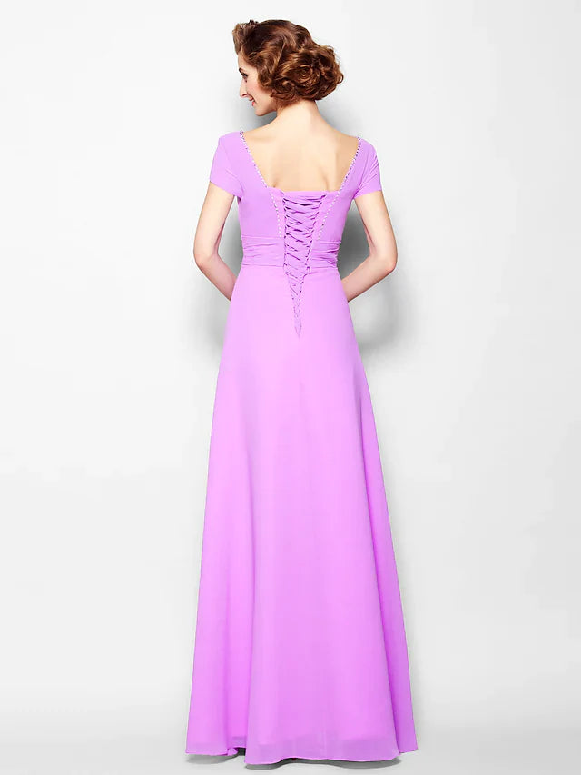 Close-up of the lace-up square neckline and ruched short sleeves on the georgette dress.