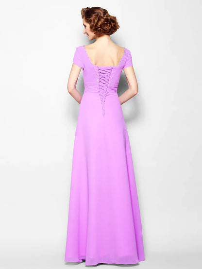 Close-up of the lace-up square neckline and ruched short sleeves on the georgette dress.