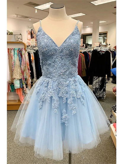 Model wearing an A-Line floral homecoming dress with spaghetti straps and appliques.