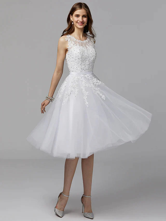 Model wearing an elegant A-line floral lace tea-length prom dress with an illusion neckline.