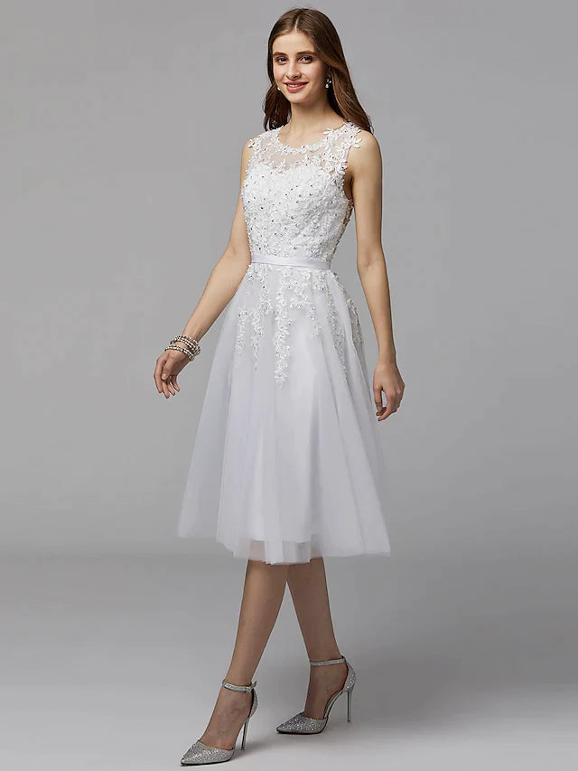 Back view of the elegant floral lace dress, featuring an illusion back and tea-length hem.