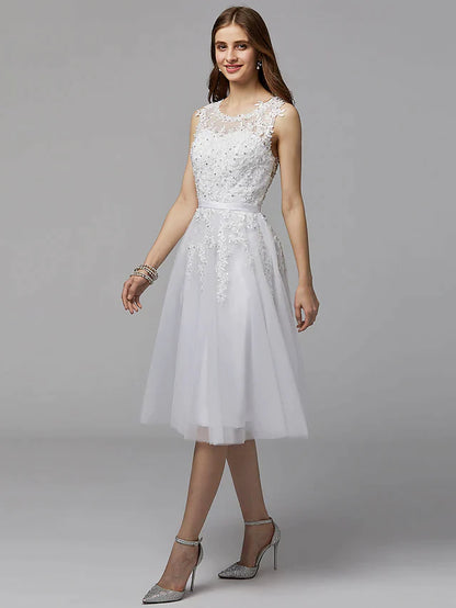 Back view of the elegant floral lace dress, featuring an illusion back and tea-length hem.