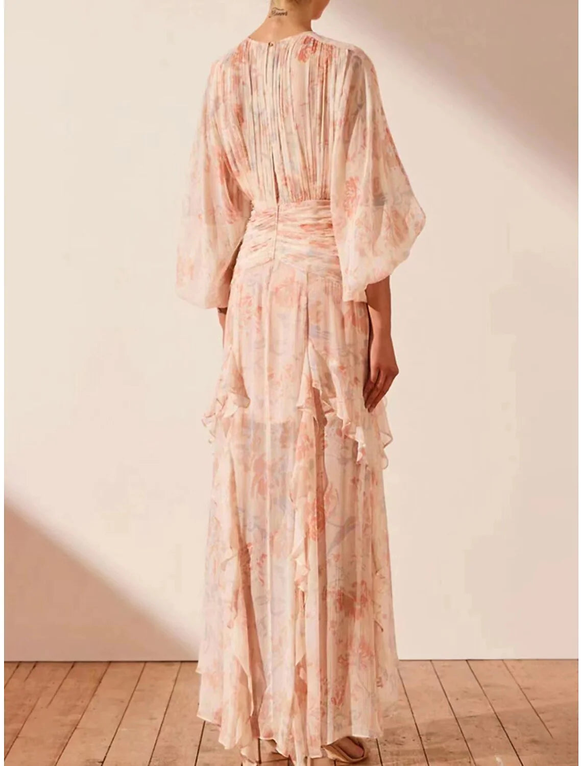 Side view of the A-line floral maxi dress, showcasing its flowing silhouette.
