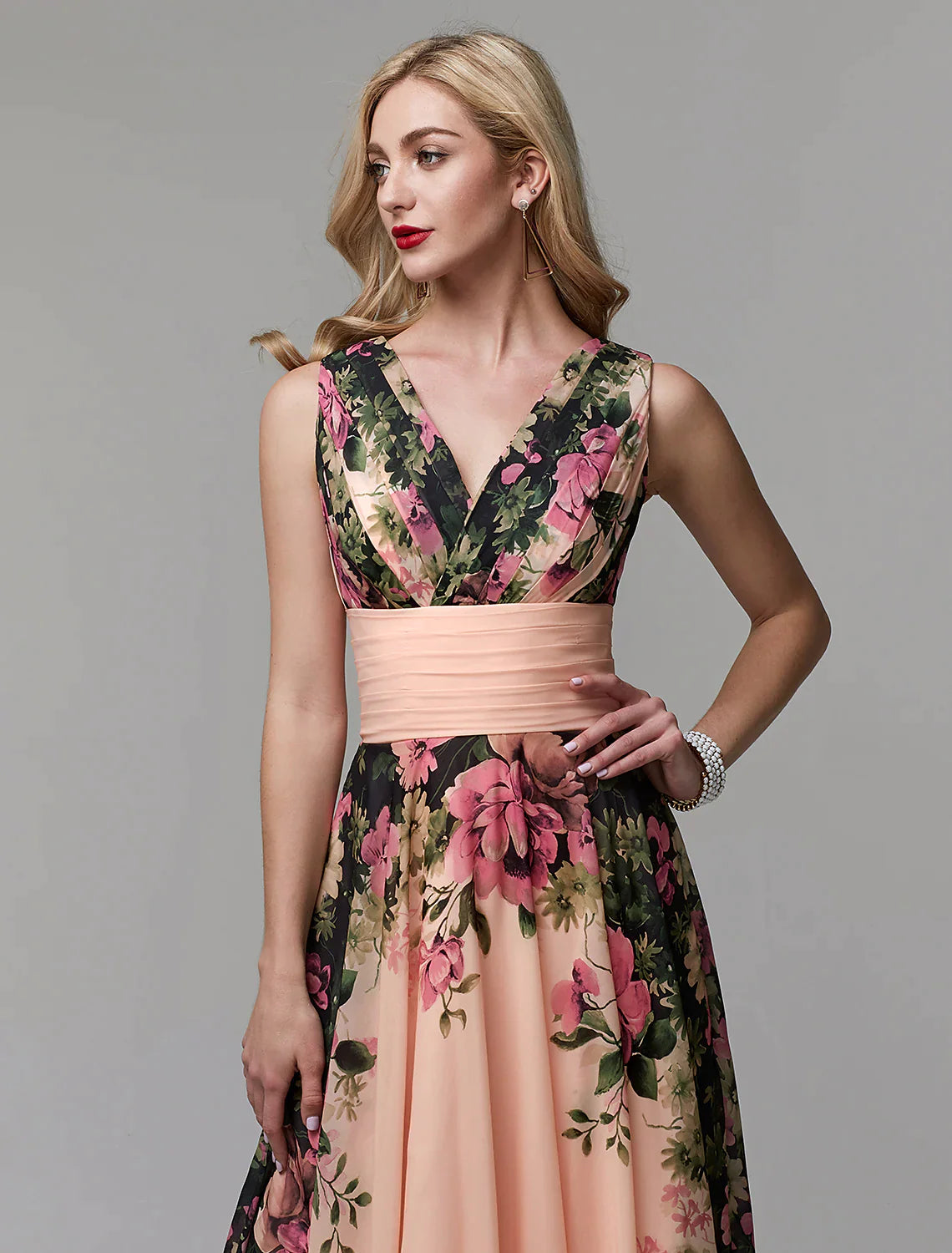 Model posing in a flowing A-line floral V-neck chiffon dress.