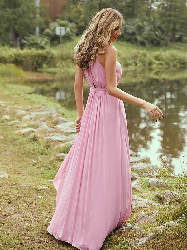 Back view of a woman wearing a light purple A-line halter bridesmaid dress.