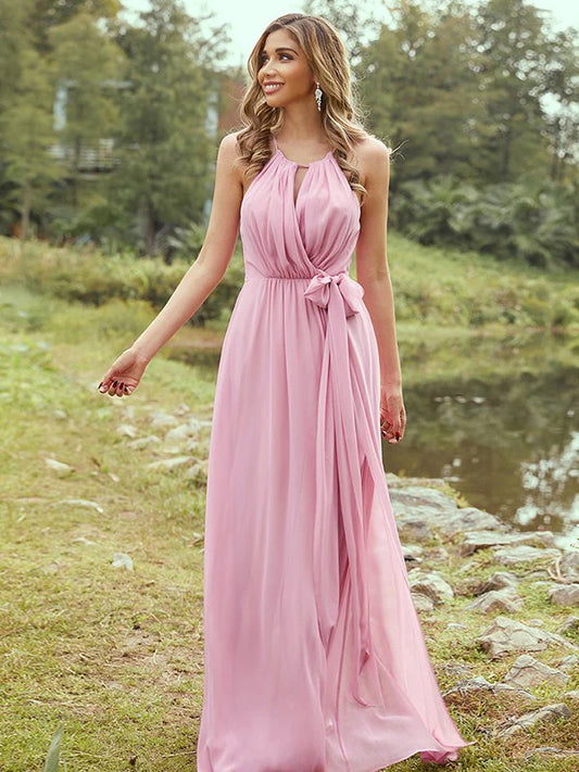 Woman wearing an elegant A-Line halter chiffon bridesmaid dress with ruffles.