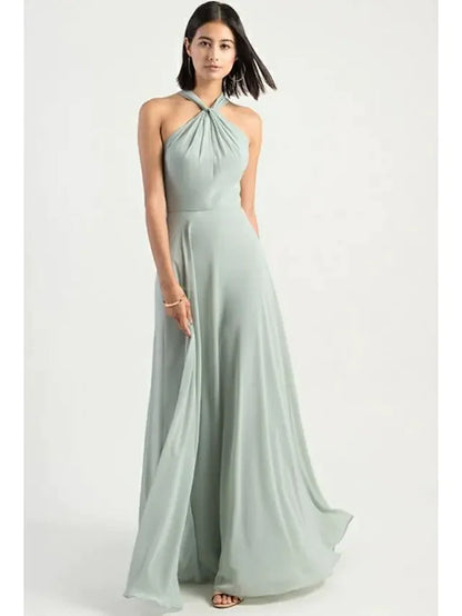 Model wearing a blue A-line halter neck chiffon bridesmaid dress with criss-cross back.