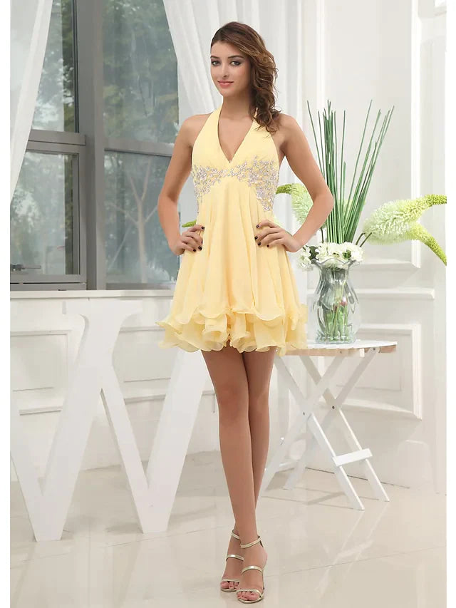 Model wearing an elegant A-line halter neck chiffon mini dress with beading.