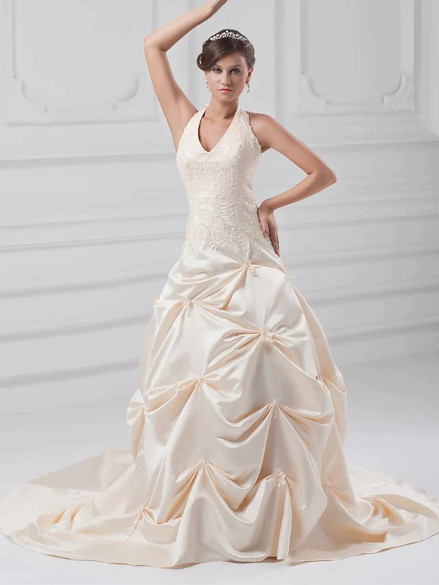 Back view of halter neck A-Line wedding gown with lace and satin.