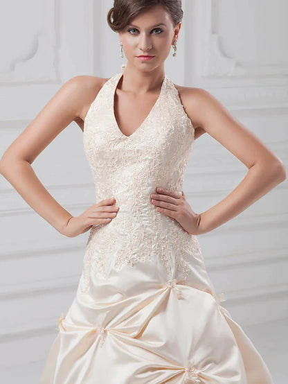 Close-up of lace bodice with intricate beading and appliques.