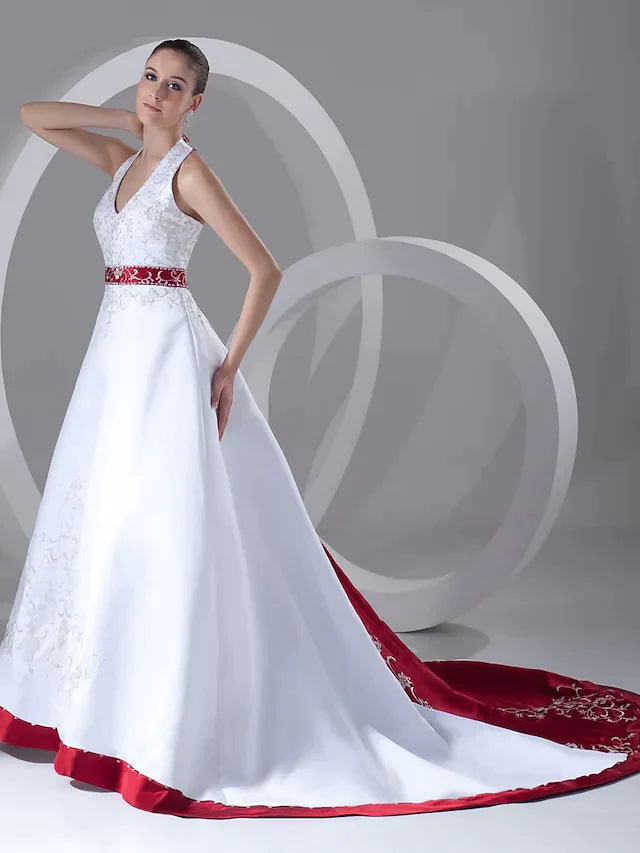 Full view of an elegant A-line halter neck wedding dress with a chapel train, featuring beading and embroidery.