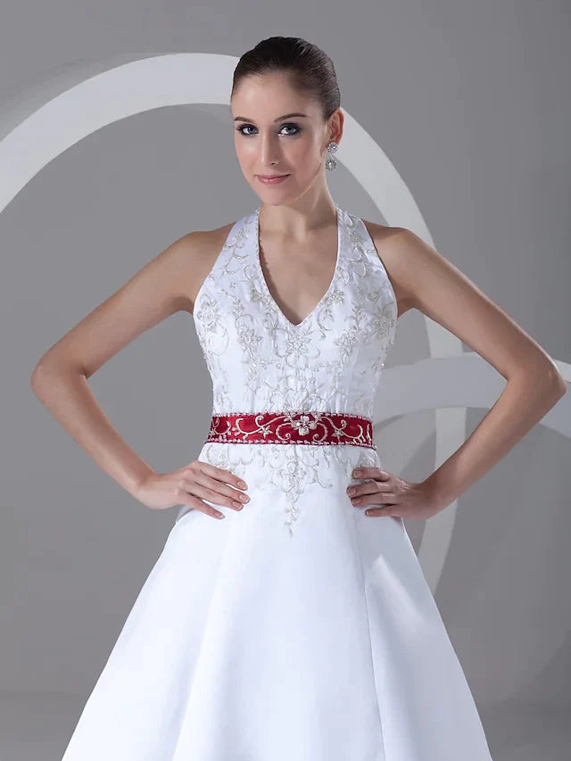 Back view of the A-line wedding dress, showcasing the flowing chapel train and luxurious satin fabric.