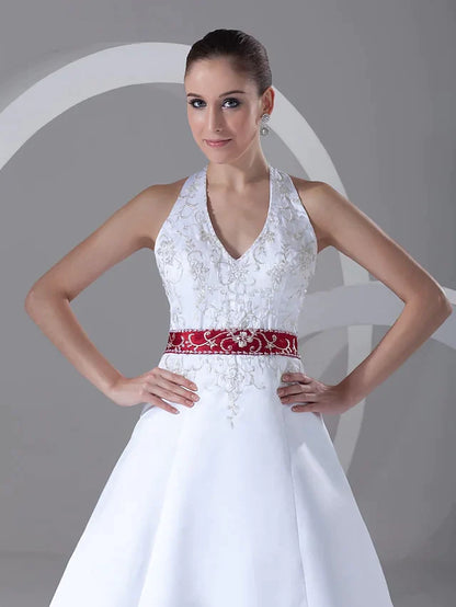 Back view of the A-line wedding dress, showcasing the flowing chapel train and luxurious satin fabric.