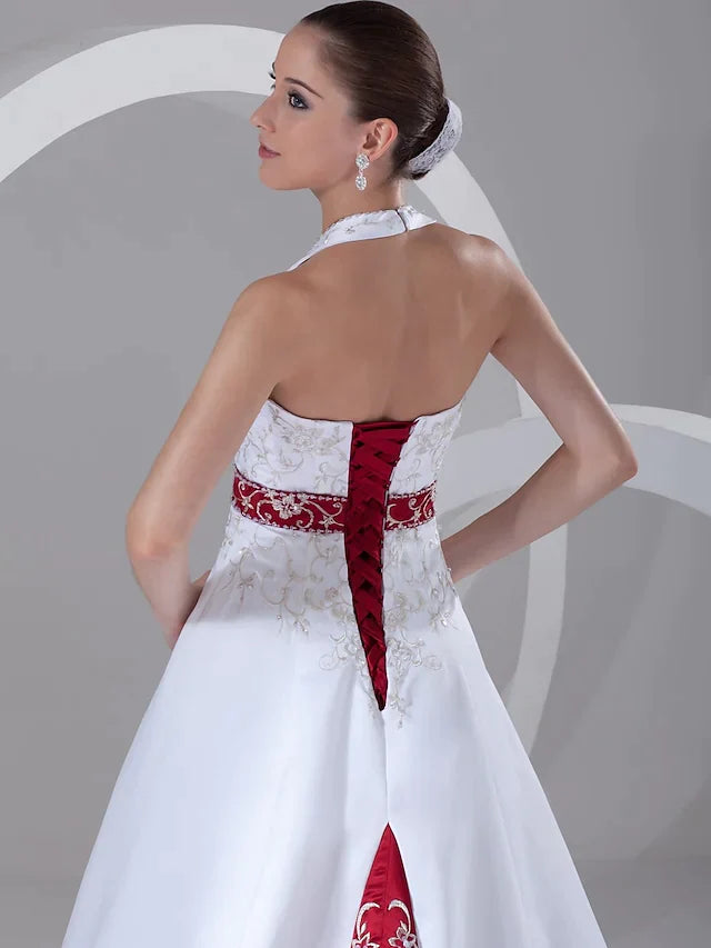 Side view of the A-line halter neck wedding dress, emphasizing its graceful silhouette and long chapel train.
