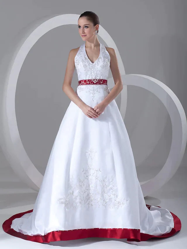Detail of the smooth satin fabric and elegant sashes on the A-line wedding dress.