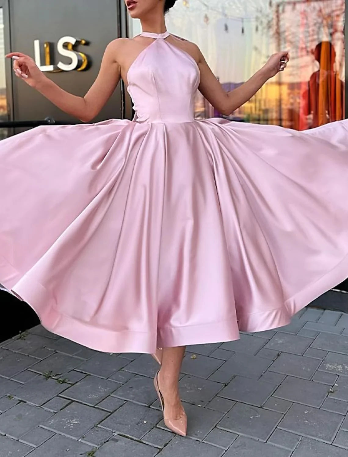 Plus size model wearing an elegant A-line halter satin dress with butterfly detail.